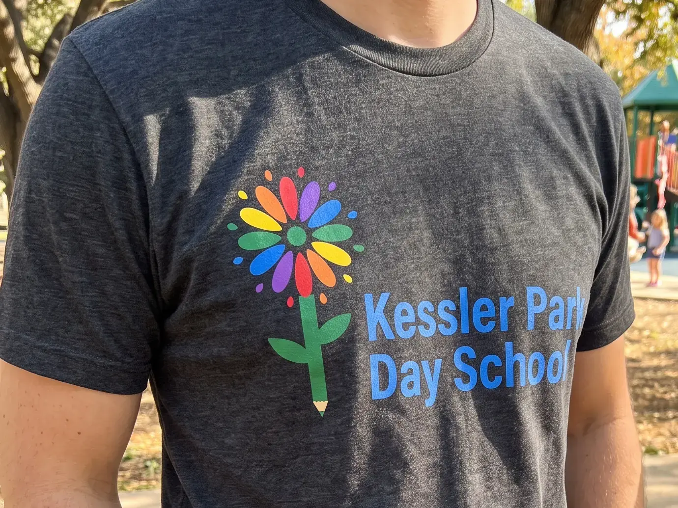 The grey Kessler Park Day School flower tee, worn at the park